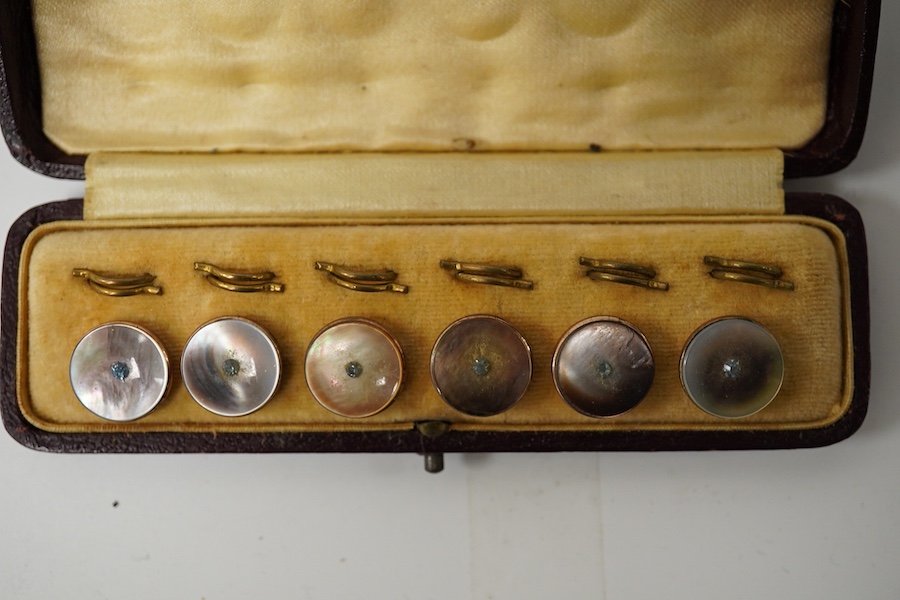 A cased set of 6 late Victorian carved lava buttons with cut steel borders, each carved with a classical female bust, 16mm and a cased set of 6 mother of pearl dress studs with gilt backs., Condition - cut steel border t